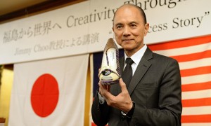 Jimmy Choo holds his one-off set of shoes using materials from Japan's Fukushima area